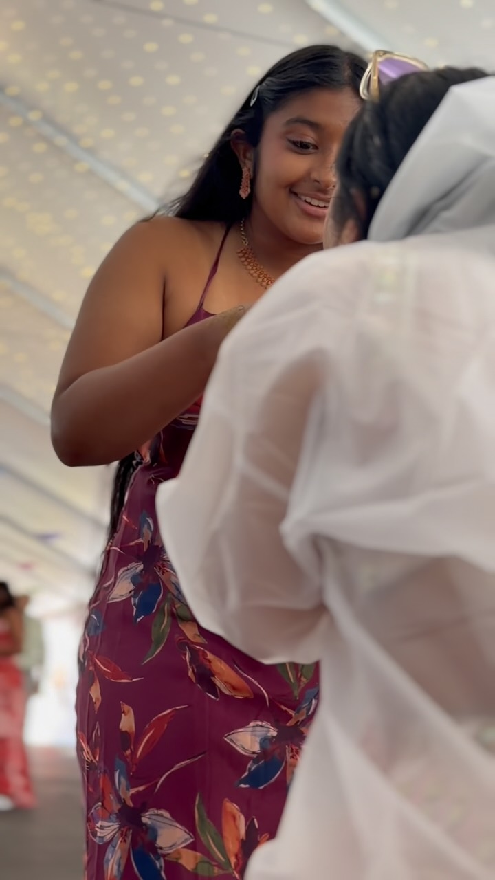 Bridesmaid adjusting the bride's veil while getting ready