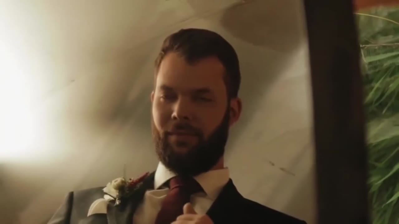 Wedding film clip: a groom watching his bride with a smile