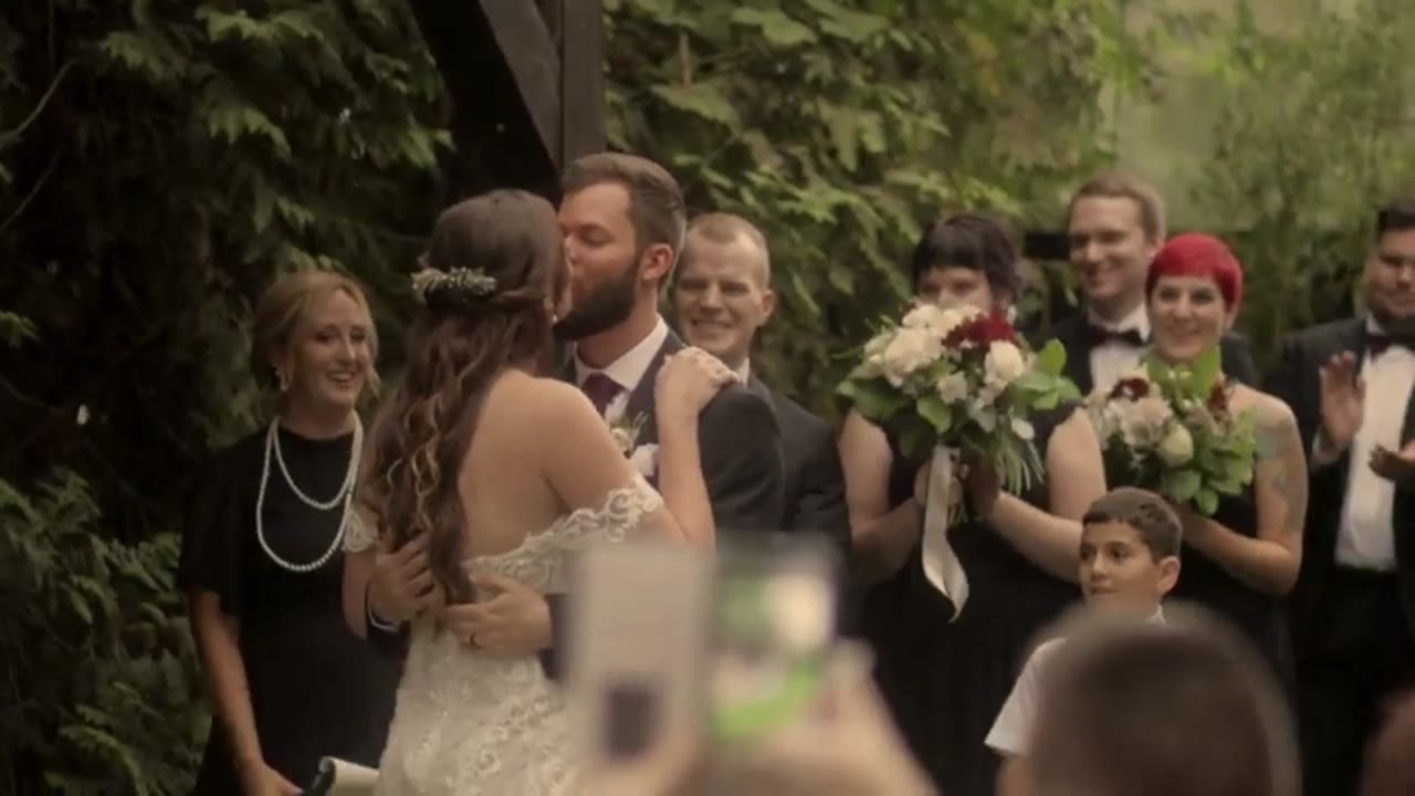 Wedding film clip: guests celebrating under string lights