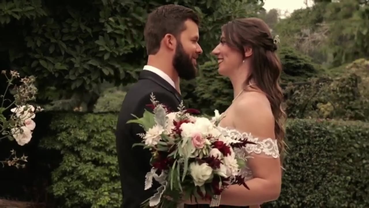 Wedding film: the couple face each other beneath the trees