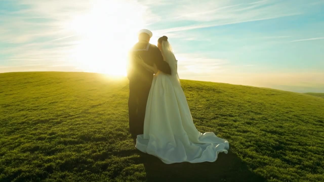 Newlyweds on a hilltop at sunset