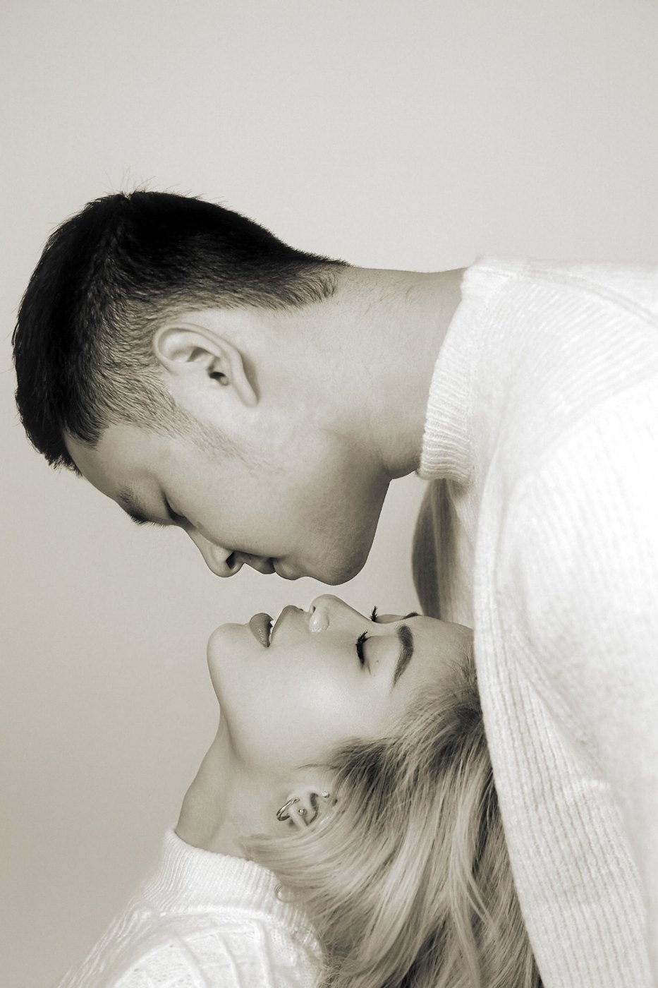 A couple nose to nose in soft sepia